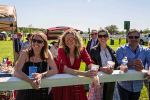 Onlookers lean on the race rail at Foxfield