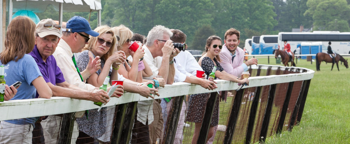 Crowd leaning on the rail watching the races at Foxfield